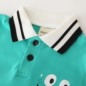 Detail of mint green polo shirt collar with stripe pattern and cartoon eye print