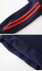 Detail of navy boy's hoodie showing red sleeve stripes and warm fleece lining