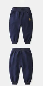 Front and back view of kids navy cotton joggers with colorful tiger embroidery details