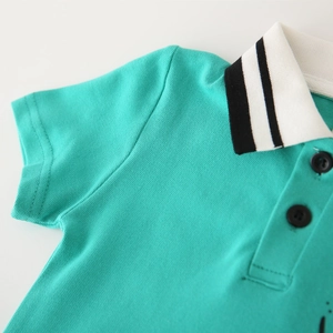 Detailed macro view of the turquoise pique polo collar with black and white stripes