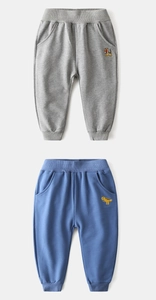 Detail of kids knit joggers featuring dinosaur and tiger embroidery with ribbed waist