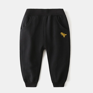 Detail of kids black jogger pants featuring yellow dinosaur embroidery and elastic waist