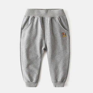 Detail of gray kids joggers featuring a cute cartoon tiger embroidery on soft cotton fabric