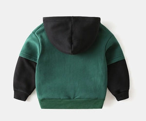 Detail of boys' patchwork hoodie showing dark green and black rib-knit cuffs and hem
