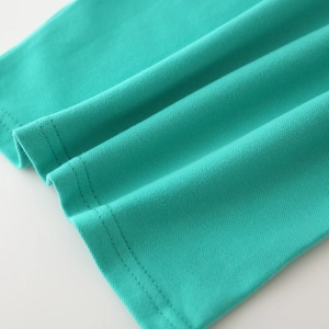Detail of teal cotton pique fabric with double-needle stitching on the t-shirt hem
