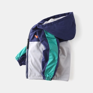 Kids fleece lined hooded windbreaker with dinosaur print in navy and green patchwork