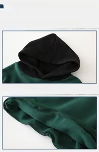 Detailed macro view of dark green hooded sweatshirt featuring ribbed hem and fleece lining