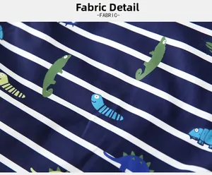 Detailed fabric macro shot of boys' thick hoodie with stripes and cartoon dinosaur prints