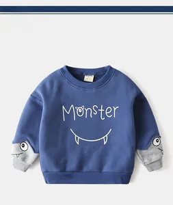 Detailed view of kids crewneck sweatshirt with Monster graphic and grey sleeve contrast