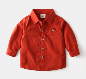 Detail of boys' orange long-sleeve cotton shirt featuring classic collar and triangle pocket