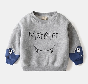 Detail of grey fleece sweatshirt featuring blue contrast cuffs and monster print