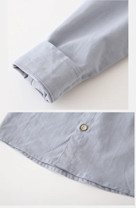Detail of light blue boys shirt showing twill fabric texture and vintage buttons