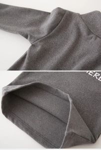 Detailed stitching of dark grey kids mock neck thermal top with ERE letter print