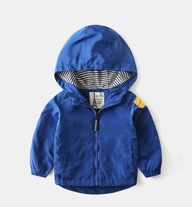 Detail view of boys thick hooded jacket in bright blue with striped inner lining