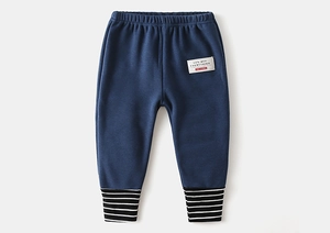 Detail of navy cotton kids joggers with striped cuffs and stylish letter patch