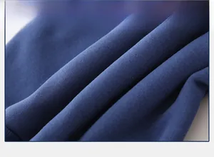 Close-up of soft navy blue cotton knit fabric showing the warm brushed fleece texture