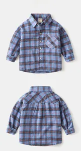 Detail of blue plaid flannel shirt for boys featuring front pocket and button-down collar