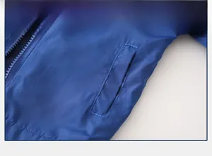 Detailed close-up of side pocket and smooth zipper on this blue padded kids' jacket