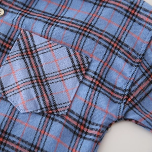 Boy's blue plaid casual shirt with front pocket and natural wood button detail