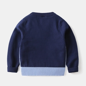 Detail view of the fine knit texture and navy blue back on this children sweater