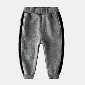 Detail of boys fleece-lined grey joggers with side stripes and elastic waistband