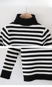 Detailed view of the ribbed turtleneck and black and white striped knit fabric