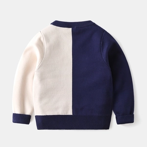 Detail of knit texture and navy ribbing on kids long-sleeve color-block sweater