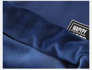 Detail shot of the soft navy blue thick fleece lining and brand label of boys sweatshirt