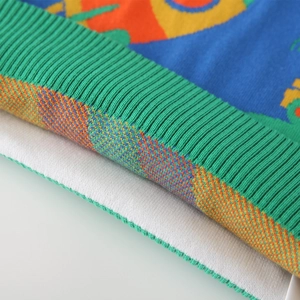 Boy's knitted sweater with colorful geometric jacquard patterns and green ribbed cuffs