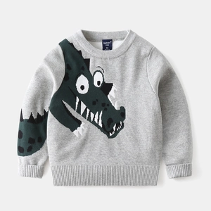 Close-up of kids' grey knitted sweater featuring a green jacquard crocodile pattern