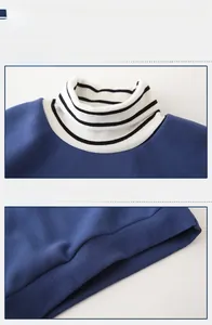 Detail view of navy blue sweatshirt featuring striped turtleneck and ribbed hem finishes
