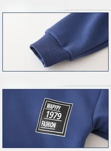 Detail showing ribbed cuffs and black square logo print on navy blue winter sweatshirt