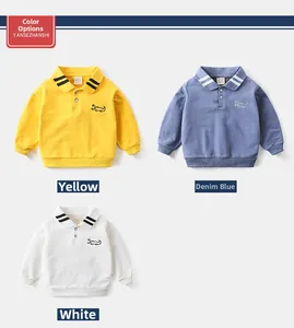 Detail of kids polo sweatshirts in yellow, denim blue, and white with crocodile embroidery