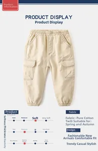 Detail of beige cotton cargo pants for boys with elastic waistband and large side pockets
