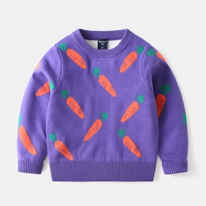 Detail of purple knitted kids sweater featuring orange carrot patterns and ribbed neckline