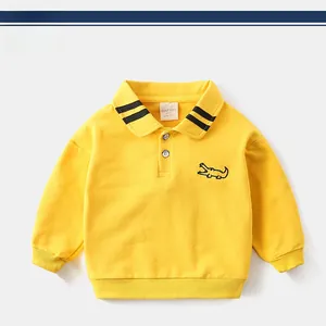 Detail of yellow toddler polo sweatshirt featuring striped collar and crocodile embroidery