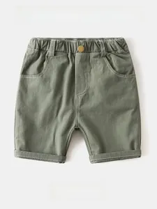 Detail of olive green cargo shorts featuring white contrast stitching and elastic waist