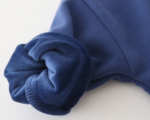 Detailed view of boys thick navy blue hoodie with warm plush fleece lining texture