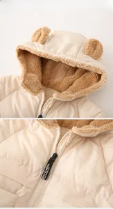 Detail of cream toddler hooded coat featuring plush bear ears and warm sherpa lining