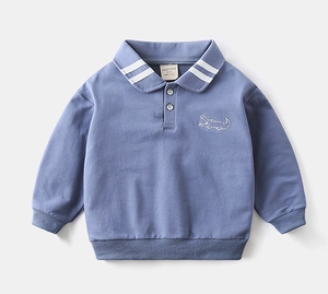 Close-up of polo collar with white stripes and crocodile embroidery on a blue sweater