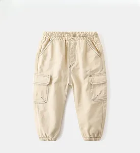 Detail of beige cargo pants showing elastic waistband and functional flap pockets