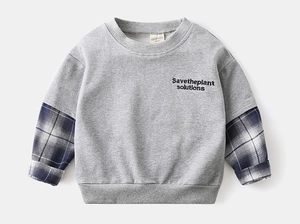 Detail of boys' grey sweatshirt with blue checkered patchwork sleeves and embroidery