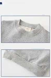 Detail view of the ribbed crew neck and elastic hem on a gray knitted boy sweatshirt
