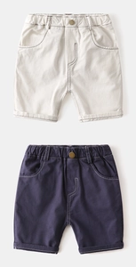 Detail of kids casual cotton shorts showing elastic waist with copper buckle and contrast stitching