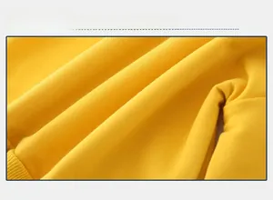 Close-up of yellow knit fabric with soft texture and ribbed cuff detail for kids sweater