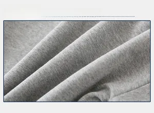 Close-up detail of soft light gray knitted cotton fabric texture for boys sweatshirt