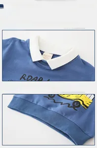 Detailed view of the white collar, car print, and ribbed hem of the blue kids' sweatshirt