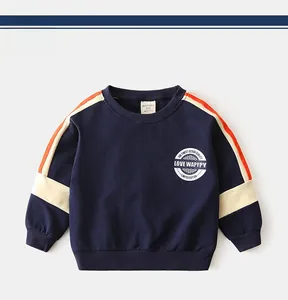Detail of navy blue kids sweatshirt with orange contrast stripes and ribbed cuffs