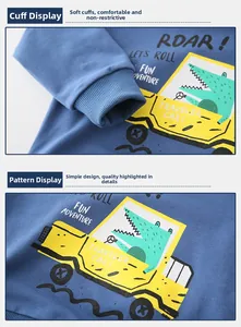 Detail of child blue sweatshirt showing ribbed cuffs and yellow crocodile car print