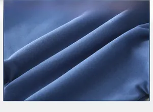 Close-up of deep blue knitted fabric texture showing soft skin-friendly cotton material